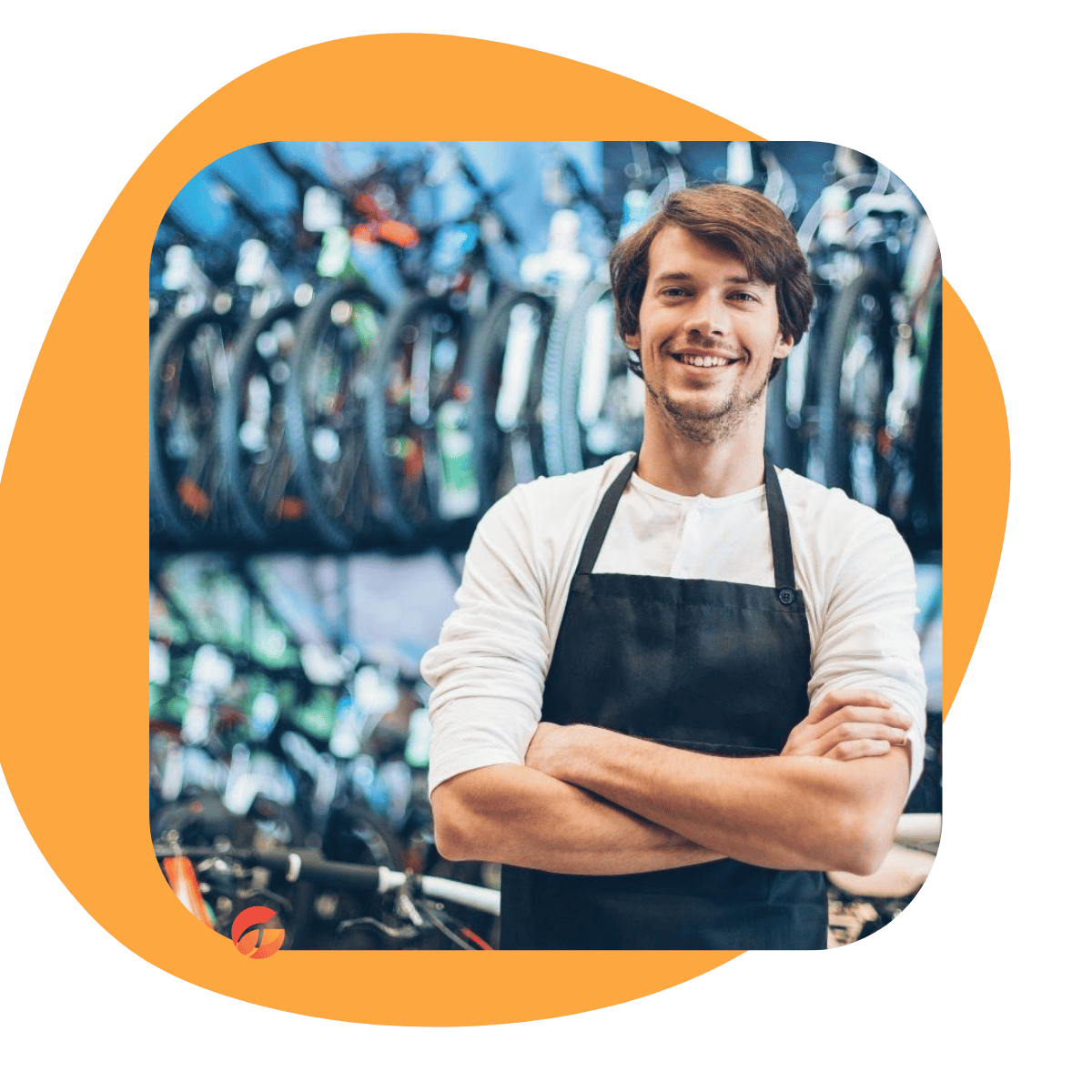 A smiling man wearing a white long-sleeve shirt and a black apron stands with arms crossed in front of a blurred background of bicycles, set within an orange rounded graphic shape on a white background.